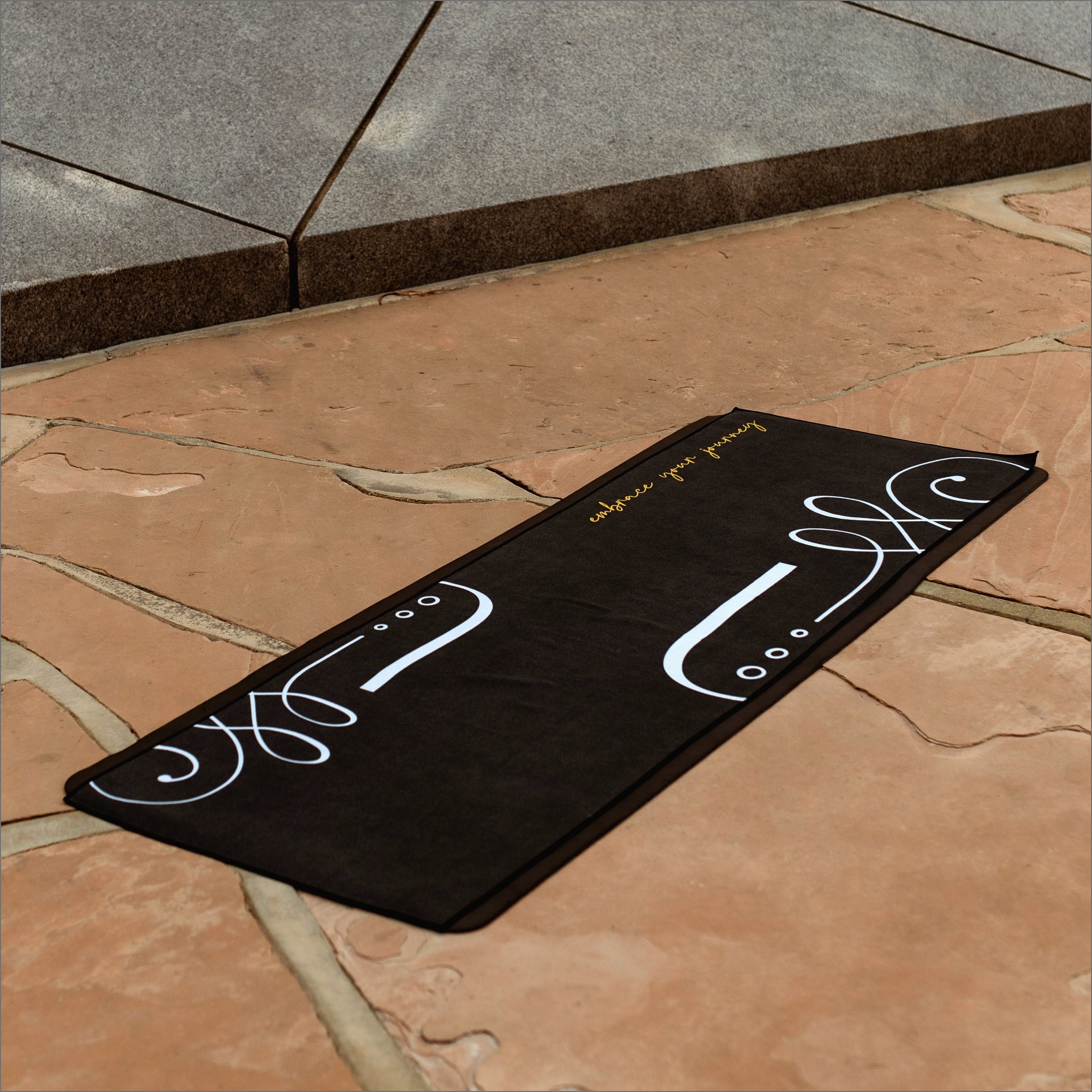 close up of black onyx hot yoga towel showcasing luxurious microfiber blend for non-slip during heated practice
