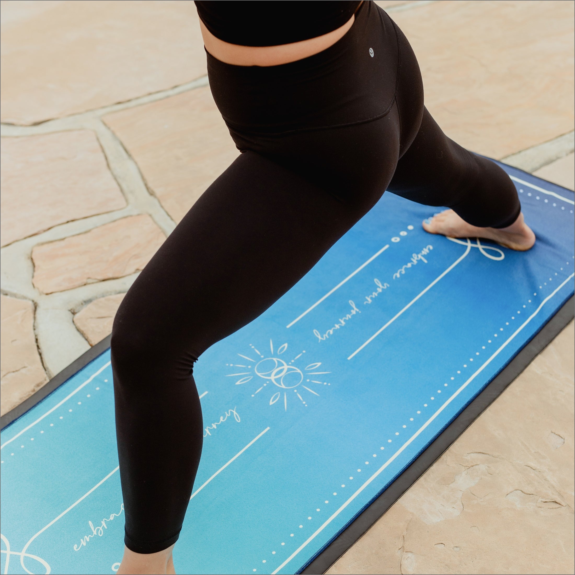 yogi practicing yoga on blue Ananta Unalome Yoga non-slip, eco friendly yoga towel with 44% more grip