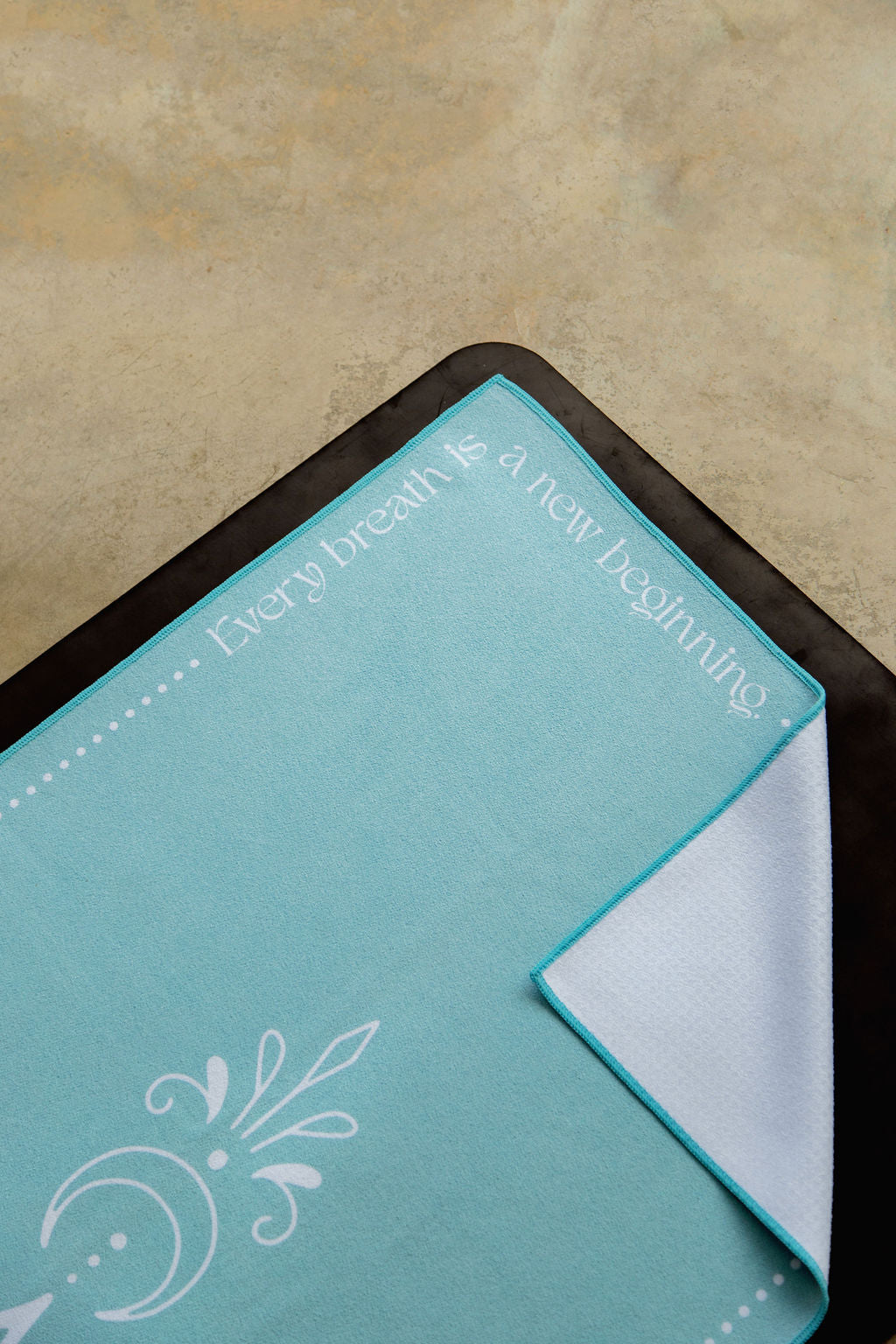 light blue yoga towel with motivational quote in white lettering; non slip grip with 44% more silicone coverage with silicone nubs shown in corner image