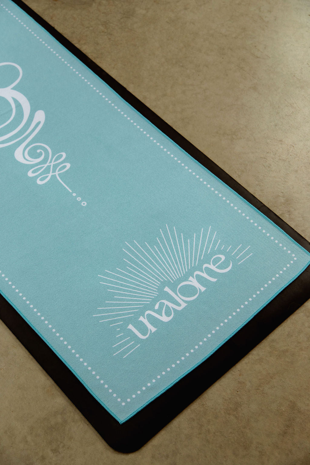 Non slip, eco friendly and luxurious microfiber for hot yoga, light blue with unalome logo detailing