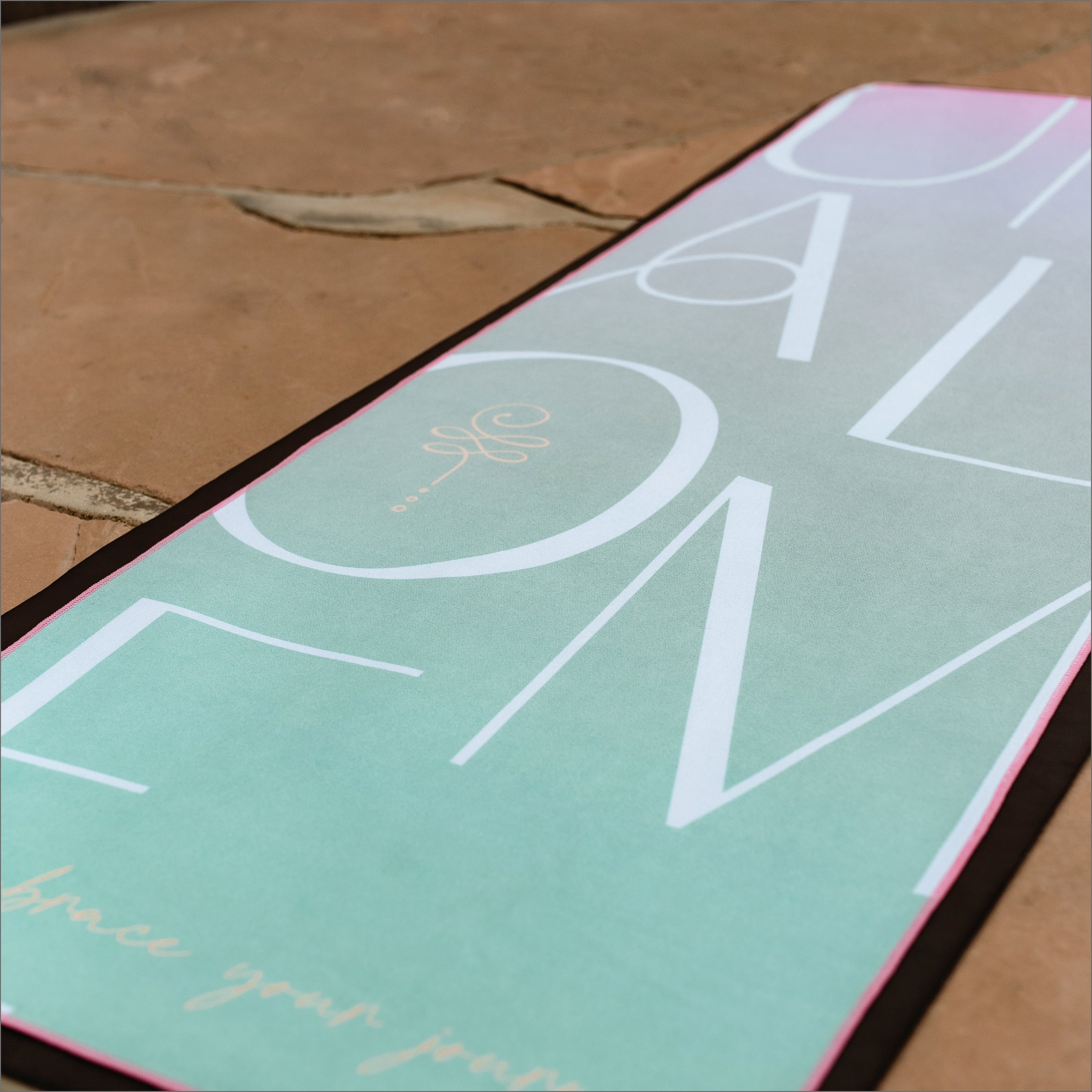 Mint and light pink hog yoga towel showing texture of luxe microfiber blend, for non-slip in hot yoga class