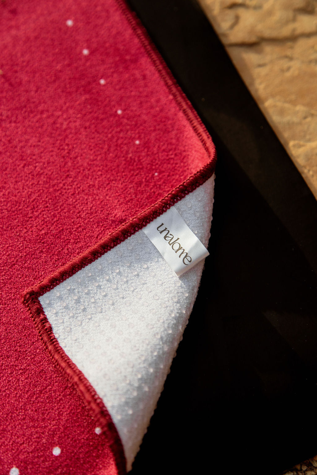 Deep pink microfiber blend and corner turn showcasing 44% more silicone coverage on back for superior grip during heated yoga classes 